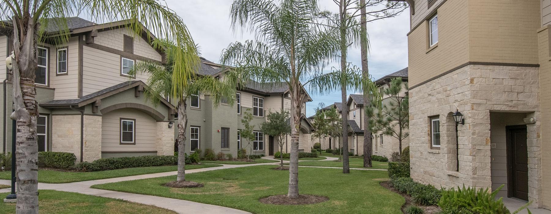 a row of apartments with palm trees